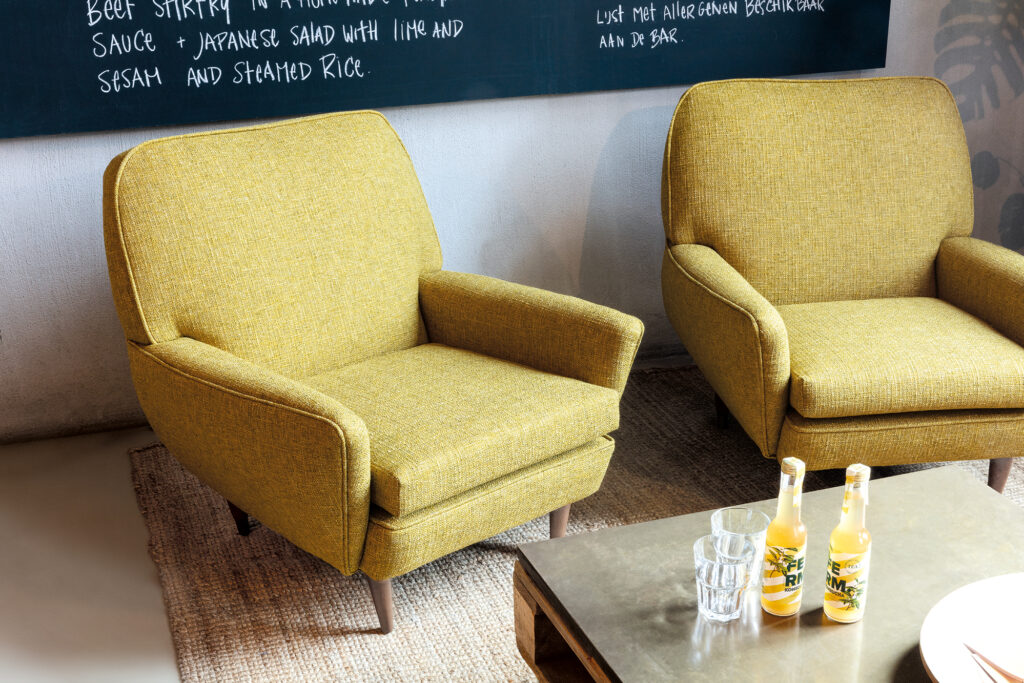Comfortable chairs upholstered in yellow Spartacus upholstery fabric