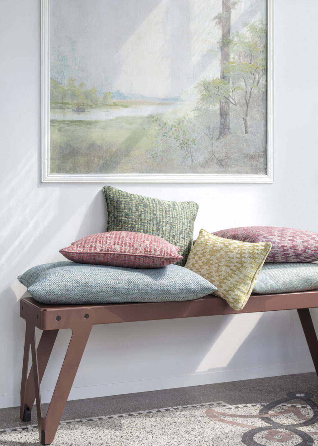 bench in sunlight with colourful pillows in easy clean fibreguard fabrics