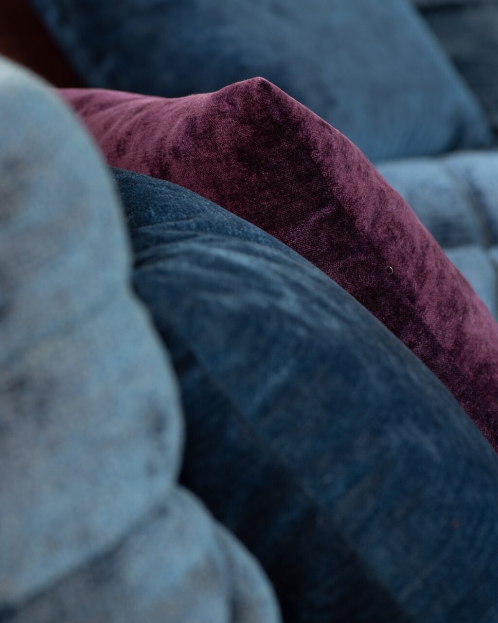 close up of blue toned velvet cushions