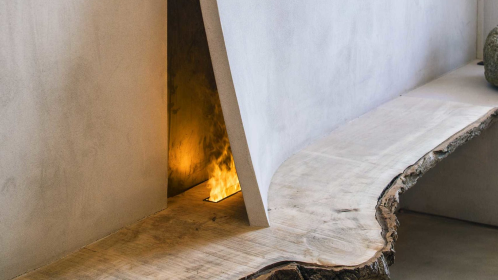 fireplace peeking out behind a curve in a stucco wall